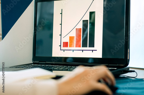 girl Manager sitting in the office and working at the computer