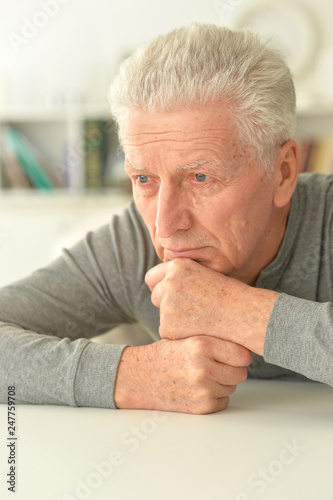 portrait of thoughtful senior man at home