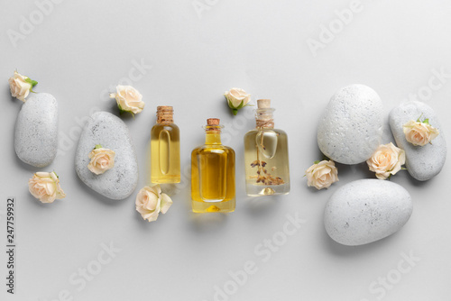 Photography Spa composition with stones and essential oil on light background