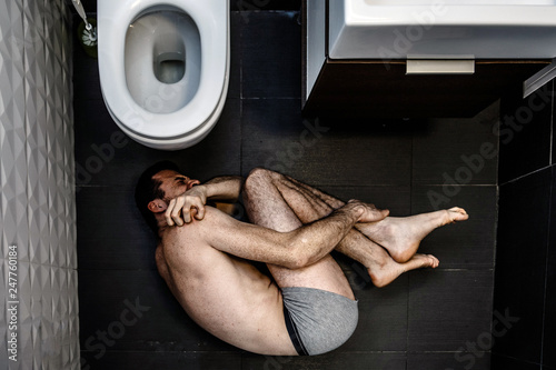 Slika na platnu Lonely young man suffer inside in rest room alone