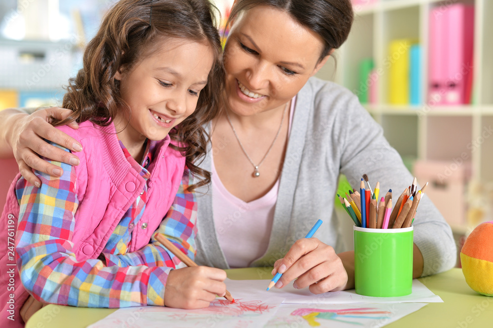 Portrait of mother with daughter drawing together Portrait of mother with daughter drawing together