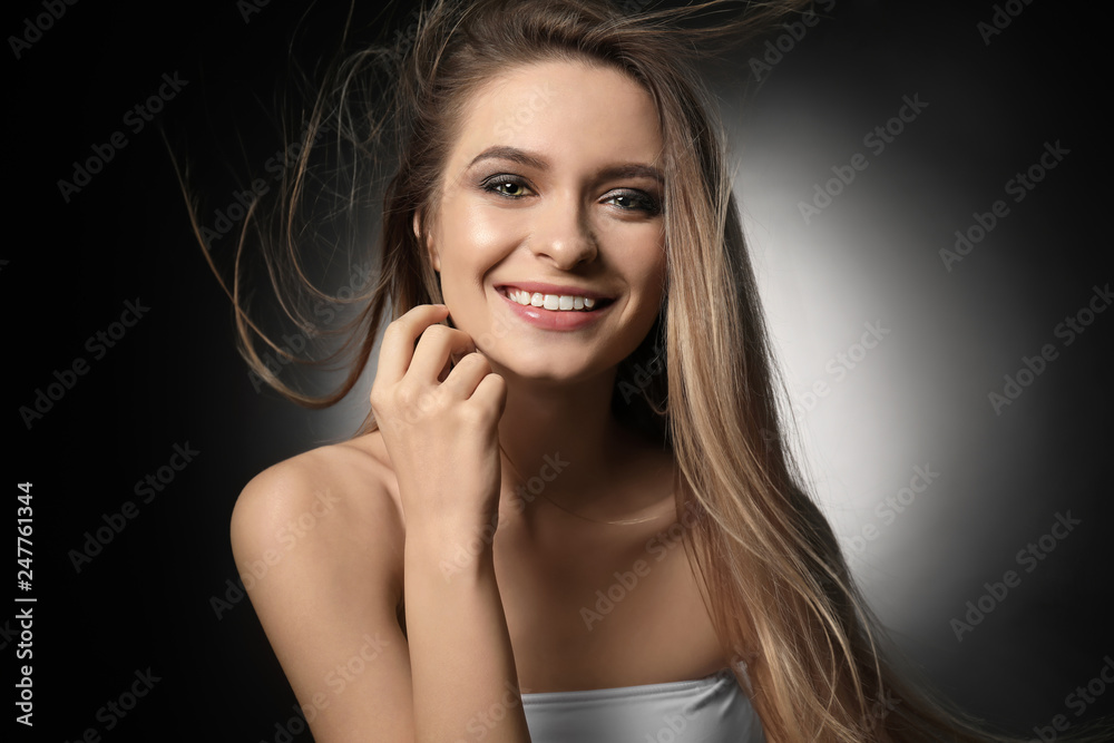 Portrait of beautiful young woman on dark background Portrait of beautiful young woman on dark background