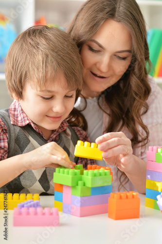 Portrait of woman and boy playing blocks game