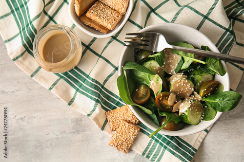 Tasty vegetable salad with tahini in bowl on table photo