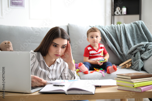 Tired mother with her son w...
