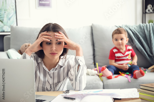 Tired mother with her son w...