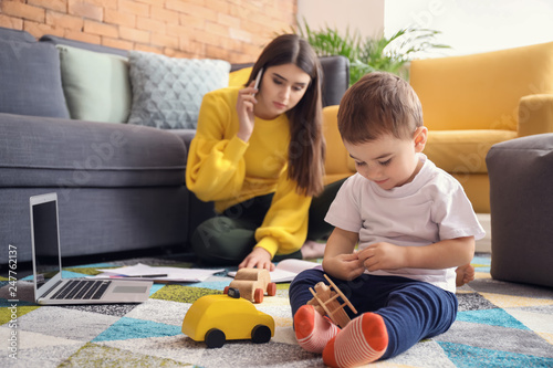 Cute little boy playing whi...