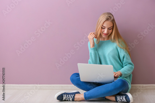 Beautiful young woman using...