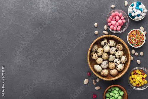 Easter holiday greeting background, with colorful candies and quail eggs
