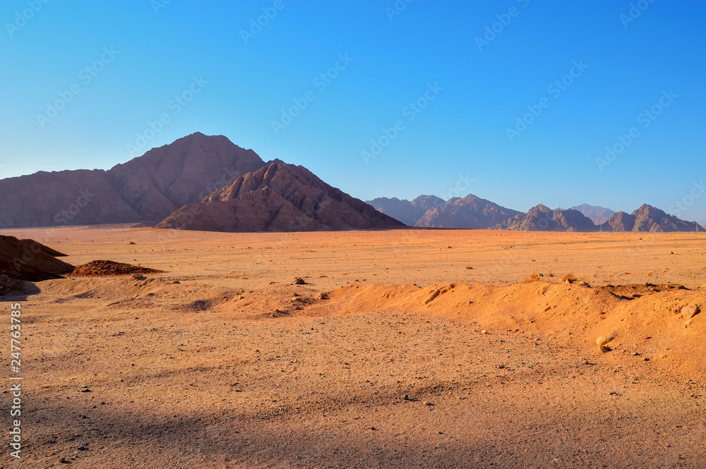 low mountains in the desert area, lit by the morning sun