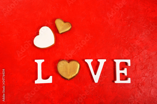 The word Love and a heart on a bright red background. view from above. Place for text