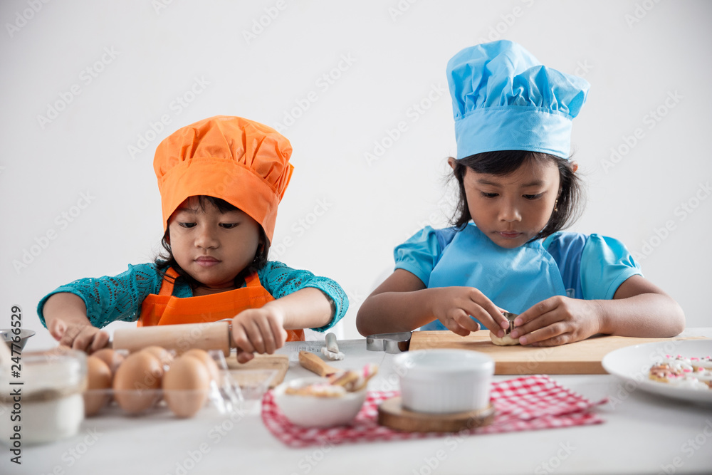 happy kids play with flour make some dough for cookie in the kitchen together happy kids play with flour make some dough for cookie in the kitchen together