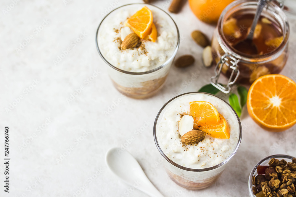 Overnight oatmeal pudding with tangerines. Top view, space for text. Overnight oatmeal pudding with tangerines. Top view, space for text.