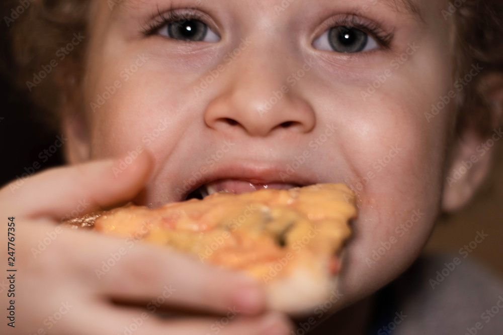 Little boy eats pizza. Portrait close-up Little boy eats pizza. Portrait close-up
