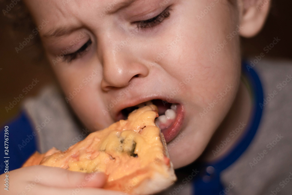 Little boy eats pizza. Portrait close-up Little boy eats pizza. Portrait close-up