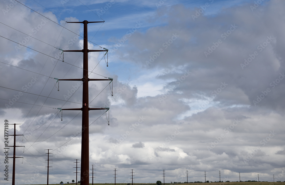 Tall steel electricity pylon and high voltage power lines against a ...
