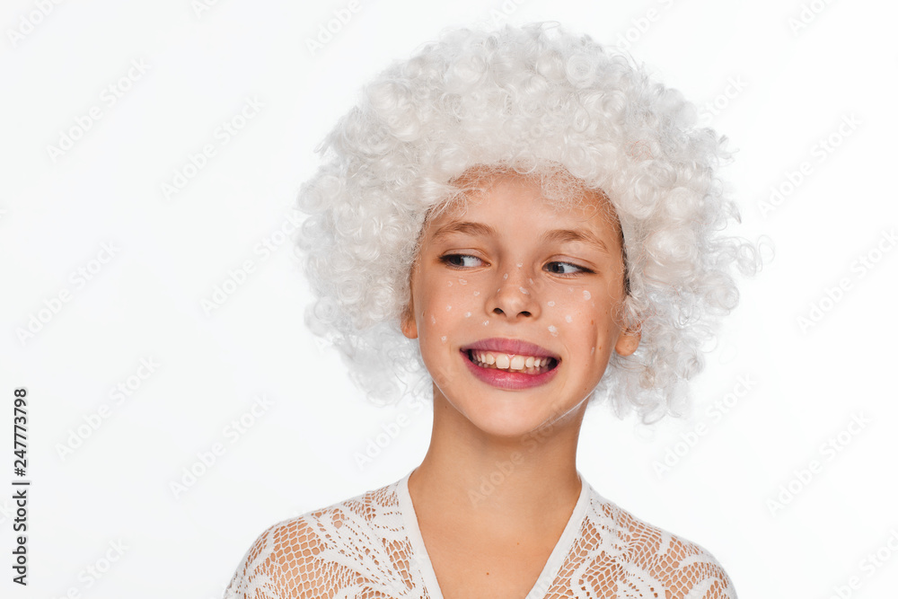 Portrait of a cheerful, energetic eight-year-old girl in a white wig and with white freckles Portrait of a cheerful, energetic eight-year-old girl in a white wig and with white freckles