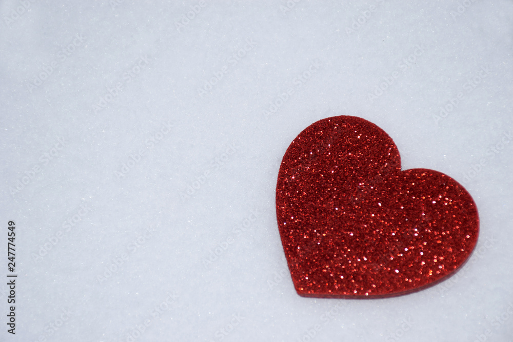 Red heart on the snow, Valentine's Day love concept. Red heart on a white snow winter background. St. Valentine's Day concept background. Red heart on the snow, Valentine's Day love concept. Red heart on a white snow winter background. St. Valentine's Day concept background.