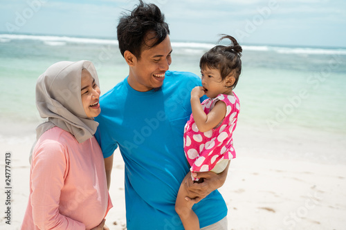 togetherness of father, mother, and daughter when vacation on the beach