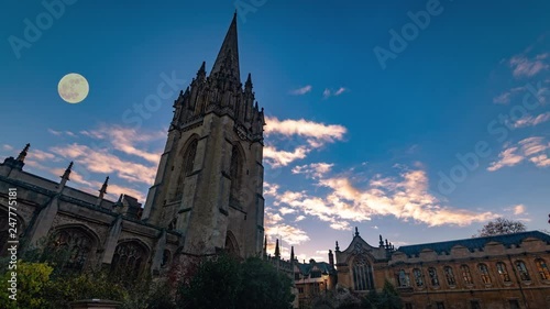 Time lapse view of St Mary the Virgin church in Oxford at sunset with full moon photo