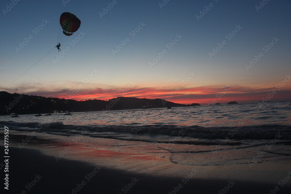 hot air balloon over the sea at sunset