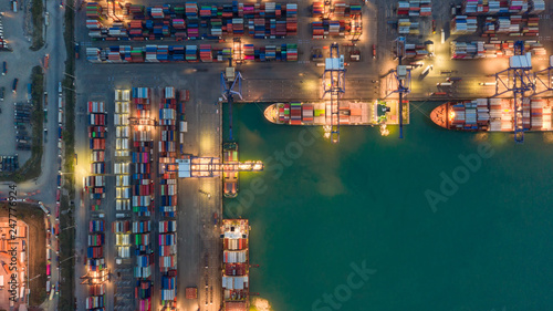 Container ship in export and import business logistics and transportation. Cargo and container box shipping to harbor by crane. Water transport International. Aerial view and top view. © MAGNIFIER