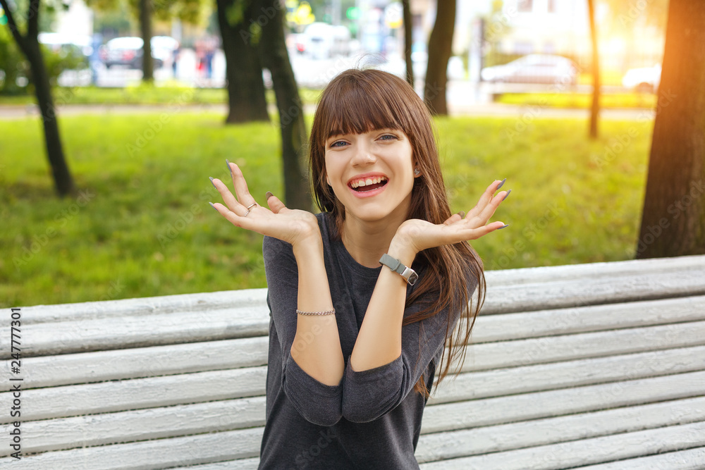 young woman in the Park emotions surprise on her face on a Sunny summer day young woman in the Park emotions surprise on her face on a Sunny summer day