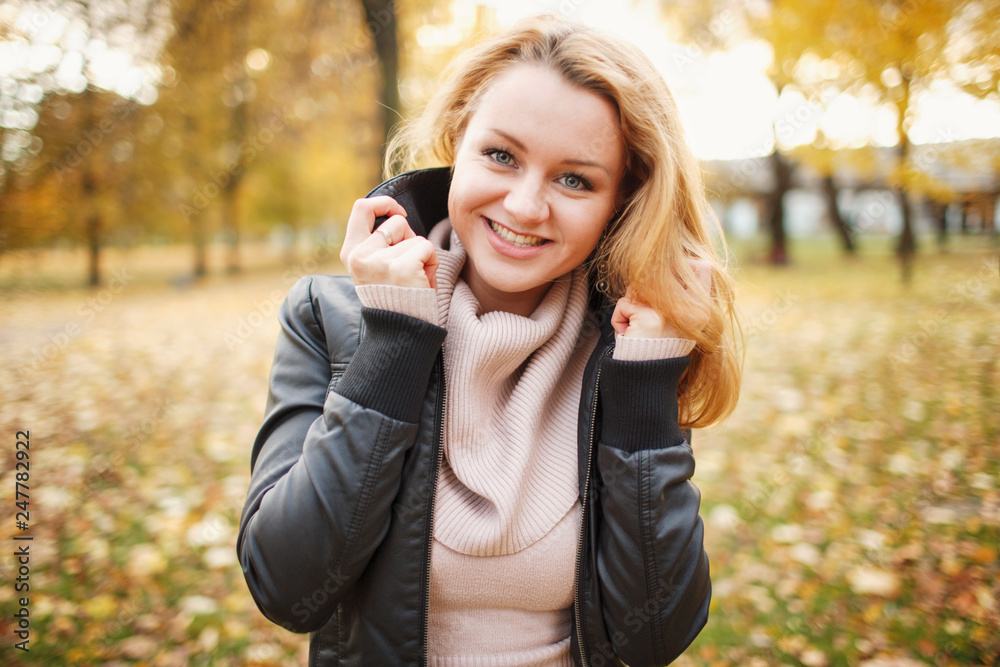 Beautiful girl walks and poses for photos in the autumn park with leaves Beautiful girl walks and poses for photos in the autumn park with leaves