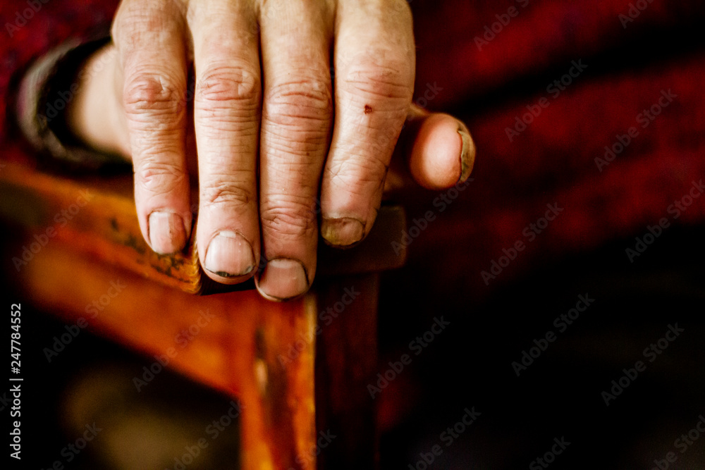 Old man sitting in a chair hand isolated with dirt Old man sitting in a chair hand isolated with dirt