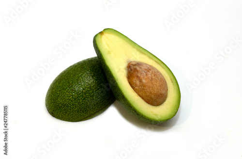 Two slices of fresh organic avocado isolated on a white background. One slice with core. Design element for product label, catalog print, web use. Tropical exotic food.