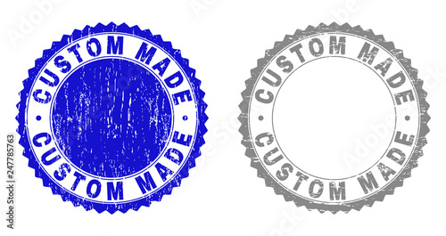 Grunge CUSTOM MADE stamp seals isolated on a white background. Rosette seals with grunge texture in blue and gray colors. Vector rubber stamp imitation of CUSTOM MADE title inside round rosette.