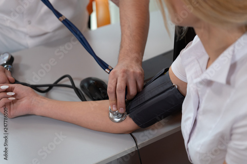 Close up Of a doctor checking blood pressure of a patient.
