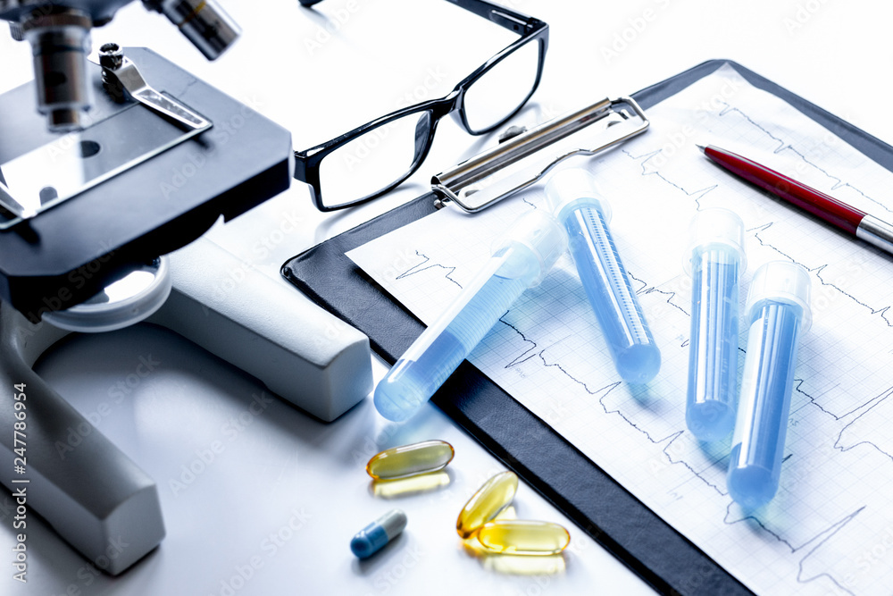 doctors desk with microscope and test tubes doctors desk with microscope and test tubes
