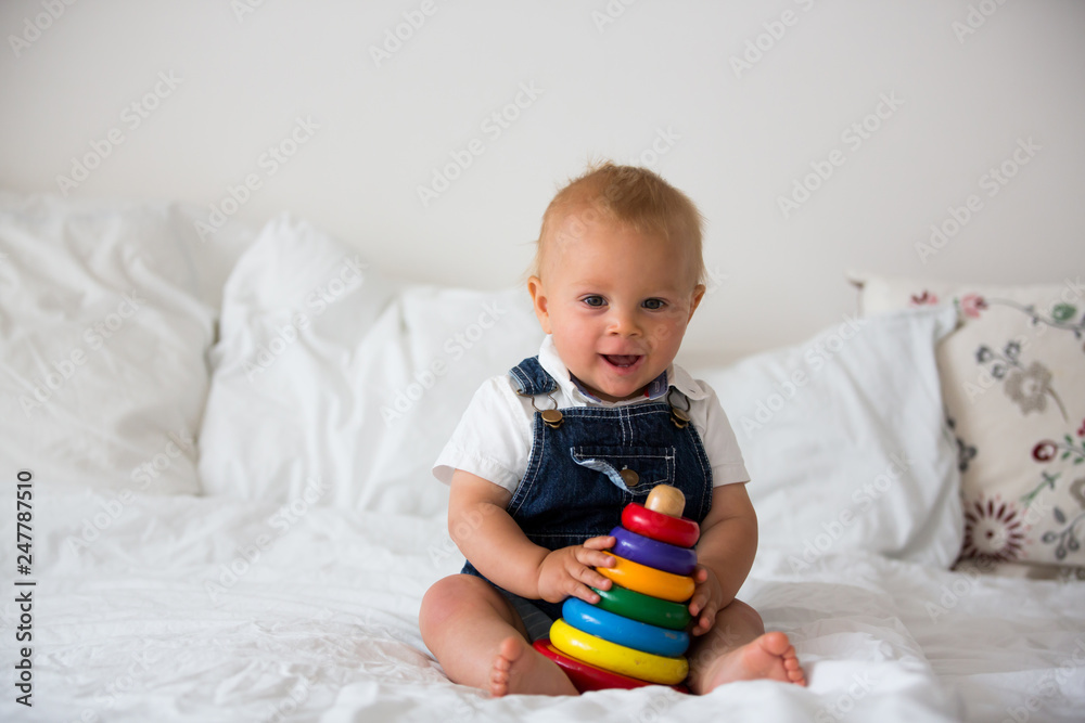 Sweet baby boy, toddler child, playing at home with colorful toy Sweet baby boy, toddler child, playing at home with colorful toy