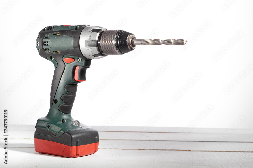 Cordless drilling tool on a close-up background. Cordless drilling tool on a close-up background.