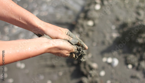 human hands crumple fresh clay, sample from sea, banner