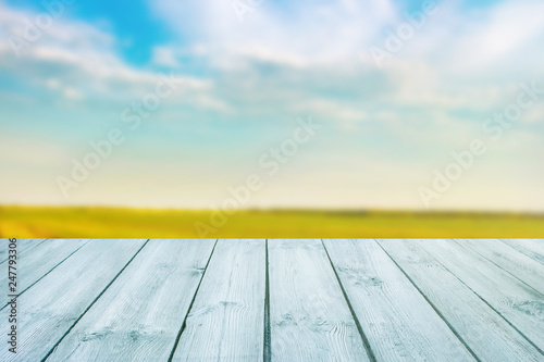 blue table on blurred background of landscape with blue sky - can use for display or montage your product.Template mock up for display of product