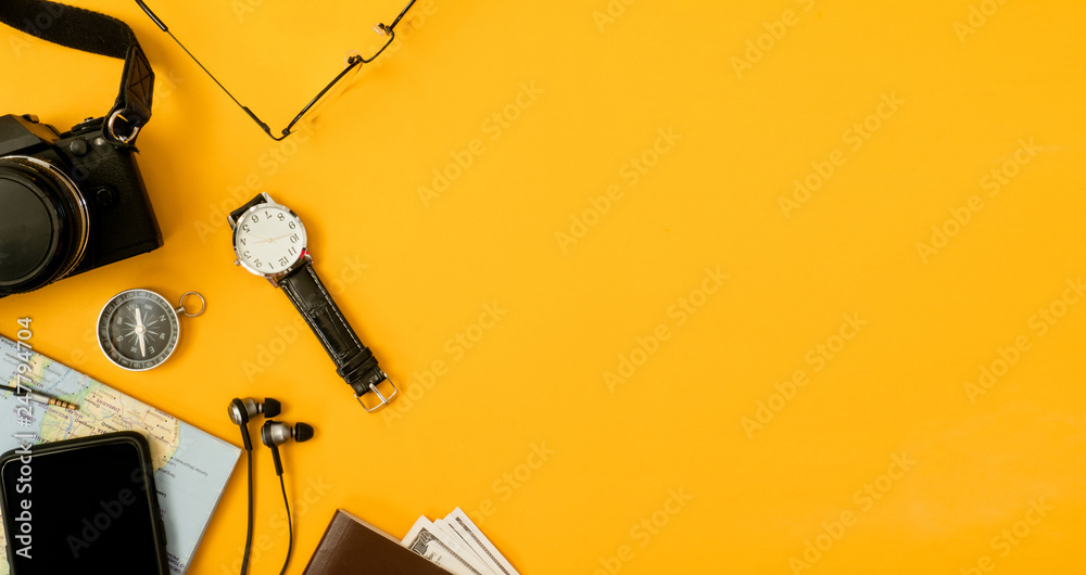 top view travel concept with camera, map, passport and travel accessories on yellow background, Tourist essentials, vintage tone effect - obrazy, fototapety, plakaty 