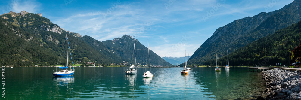 the still lake of achensee in the tyrol region of austria in europe during a clear bright calm summer day the still lake of achensee in the tyrol region of austria in europe during a clear bright calm summer day
