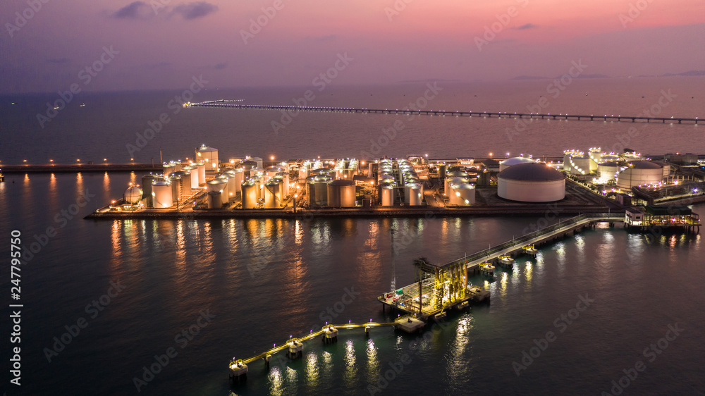 Oil and Gas terminal is industrial facility for storage of oil, gas and petrochemical products, Aeria view at twilight.