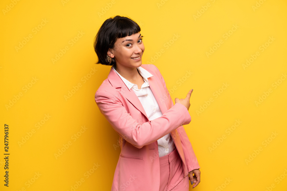 Young woman with short hair pointing back Young woman with short hair pointing back