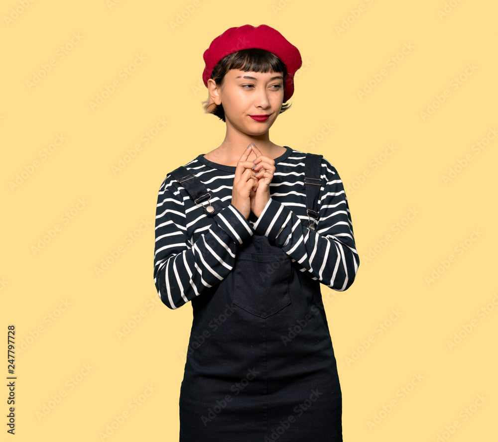Young woman with beret scheming something Young woman with beret scheming something