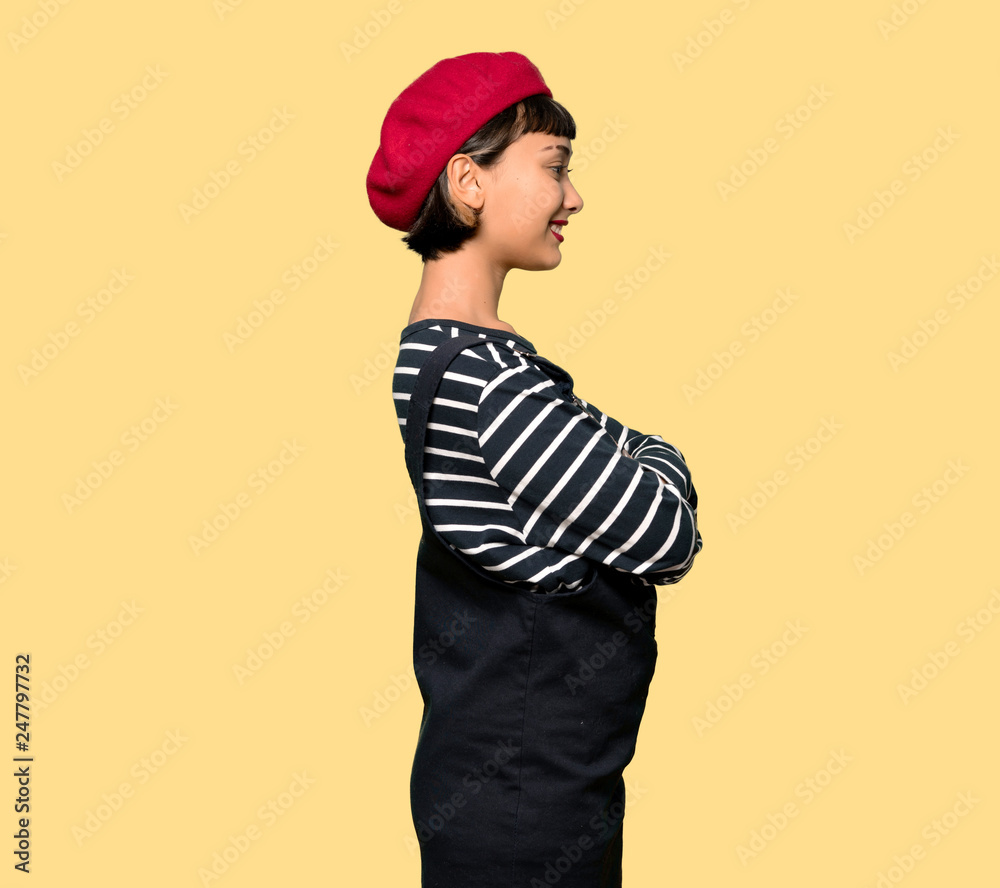 Young woman with beret in lateral position Young woman with beret in lateral position