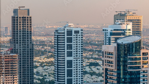 Dubai marina and JLT skyscrapers aerial skyline during sunset timelapse.