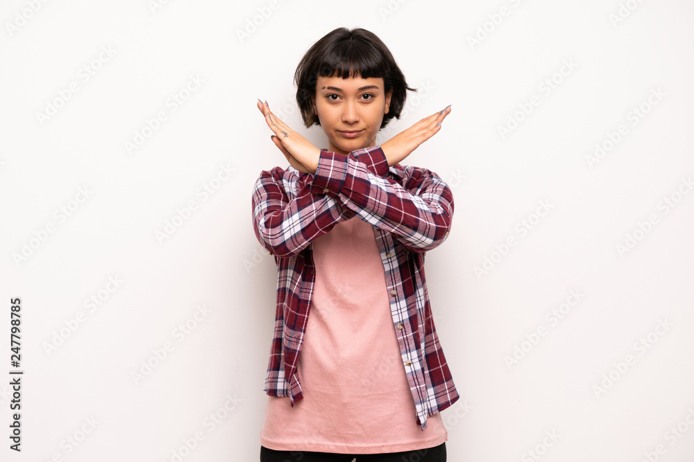 Young woman with short hair making stop sign Young woman with short hair making stop sign