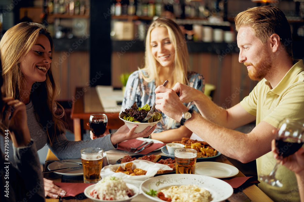 custom made wallpaper toronto digitalFriends having dinner at restaurant. Multi ethnic group.