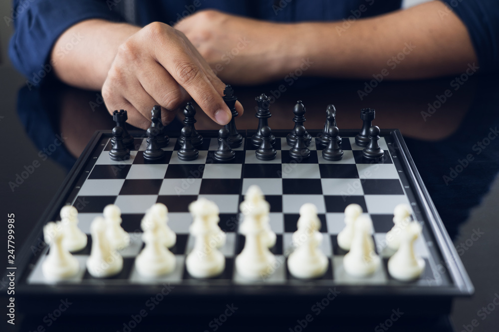 Businessman holding a King Chess is placed on a chessboard.using as background business concept and Strategy concept with copy space for your text or design. Businessman holding a King Chess is placed on a chessboard.using as background business concept and Strategy concept with copy space for your text or design.