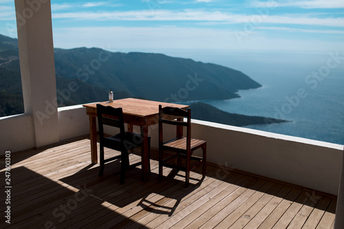table and chairs on the beach, tourist in the mountains, panoramic landscape of the Turkish mountains and the sea