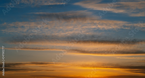 Dramatic sunset sky with orange clouds.