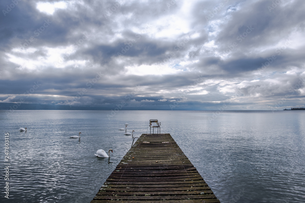 A view on a cloudy Lake Geneva from a chair on a pontoon,